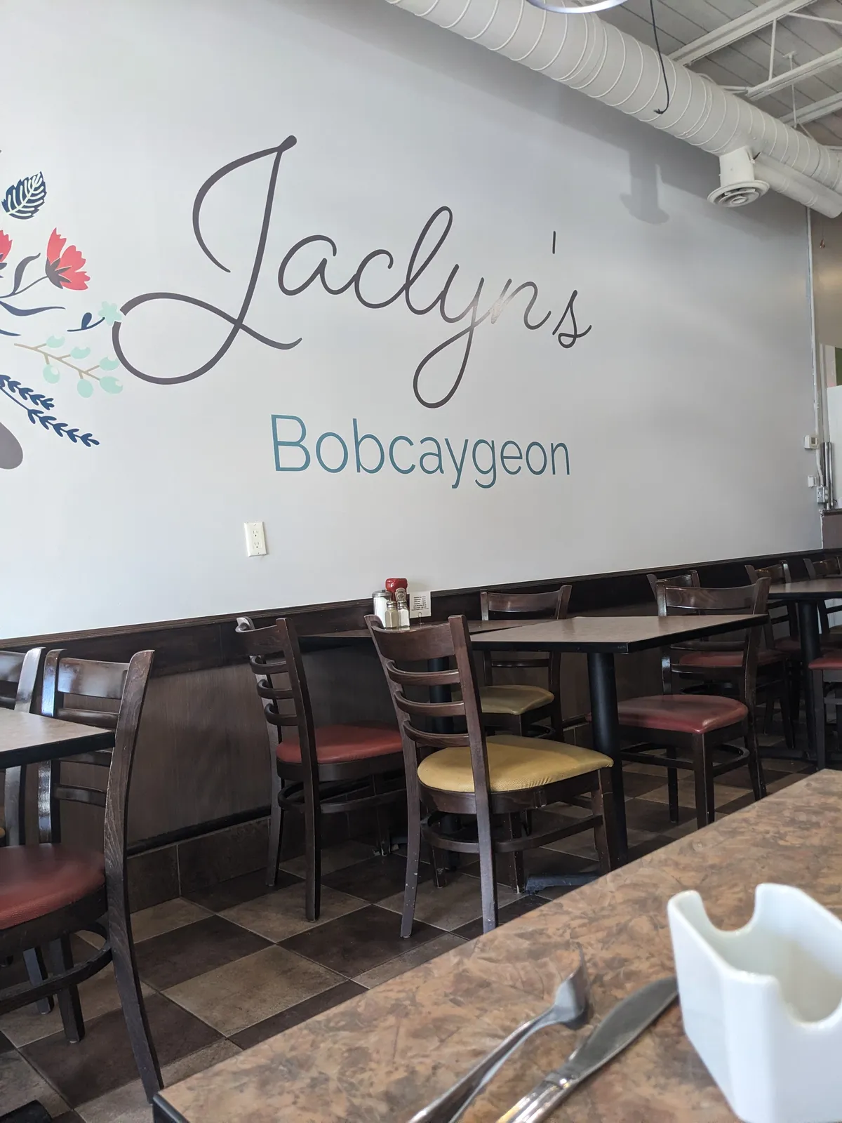 The dining room, with the Jaclyn's script logo painted on the wall