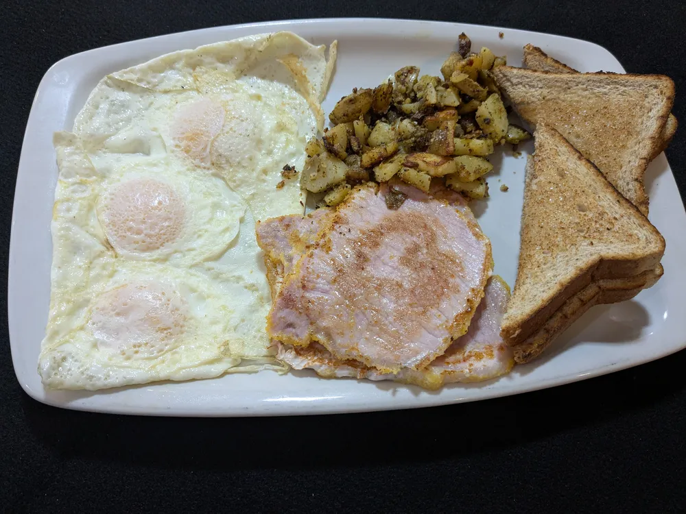 Three eggs with peameal bacon, home fries and Texas toast