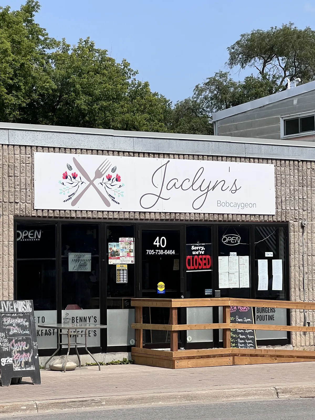 The front of Jaclyn's on Bolton Street: the script sign with a crossed knife and fork, and the patio out front